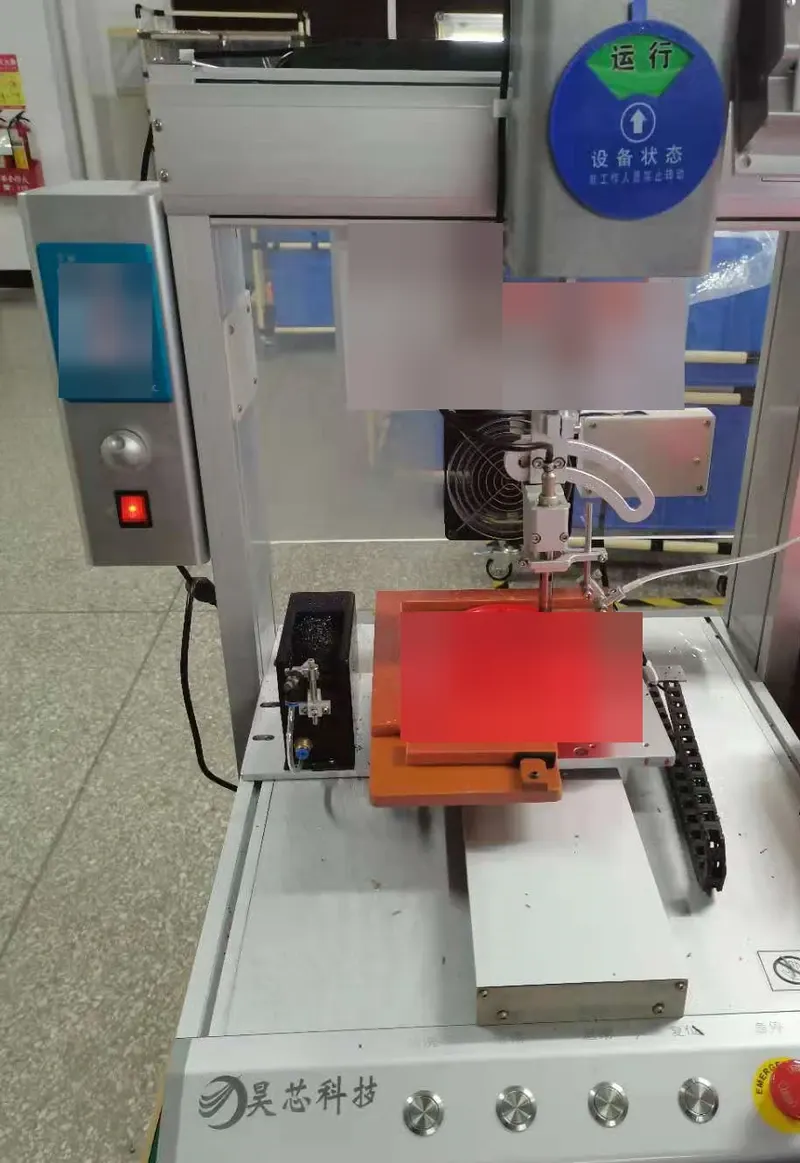 Automated soldering station showing the soldering head and work fixture