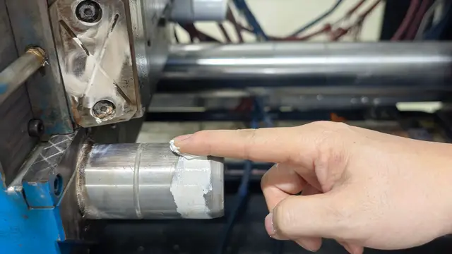 Lubricant being applied to a mold guide post at Xinyinhai