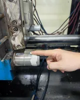 Lubricant being applied to a mold guide post during maintenance