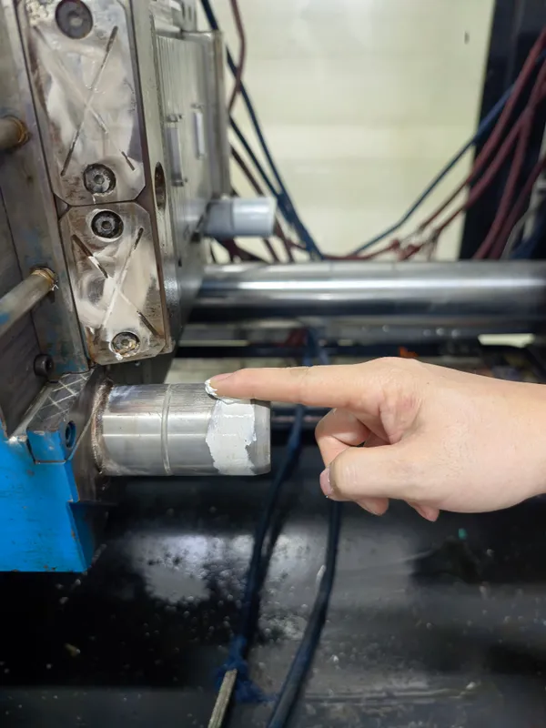 Lubricant being applied to a mold guide post during maintenance