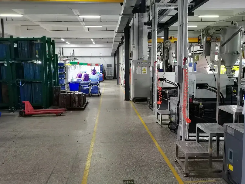 Molding equipment beside a marked workshop aisle