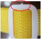 Uneven gate vestige on a white part. The ellipse identifies the uneven molded gate area.