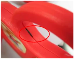 Pinched wire. The marked area shows a wire trapped at the enclosure joint.