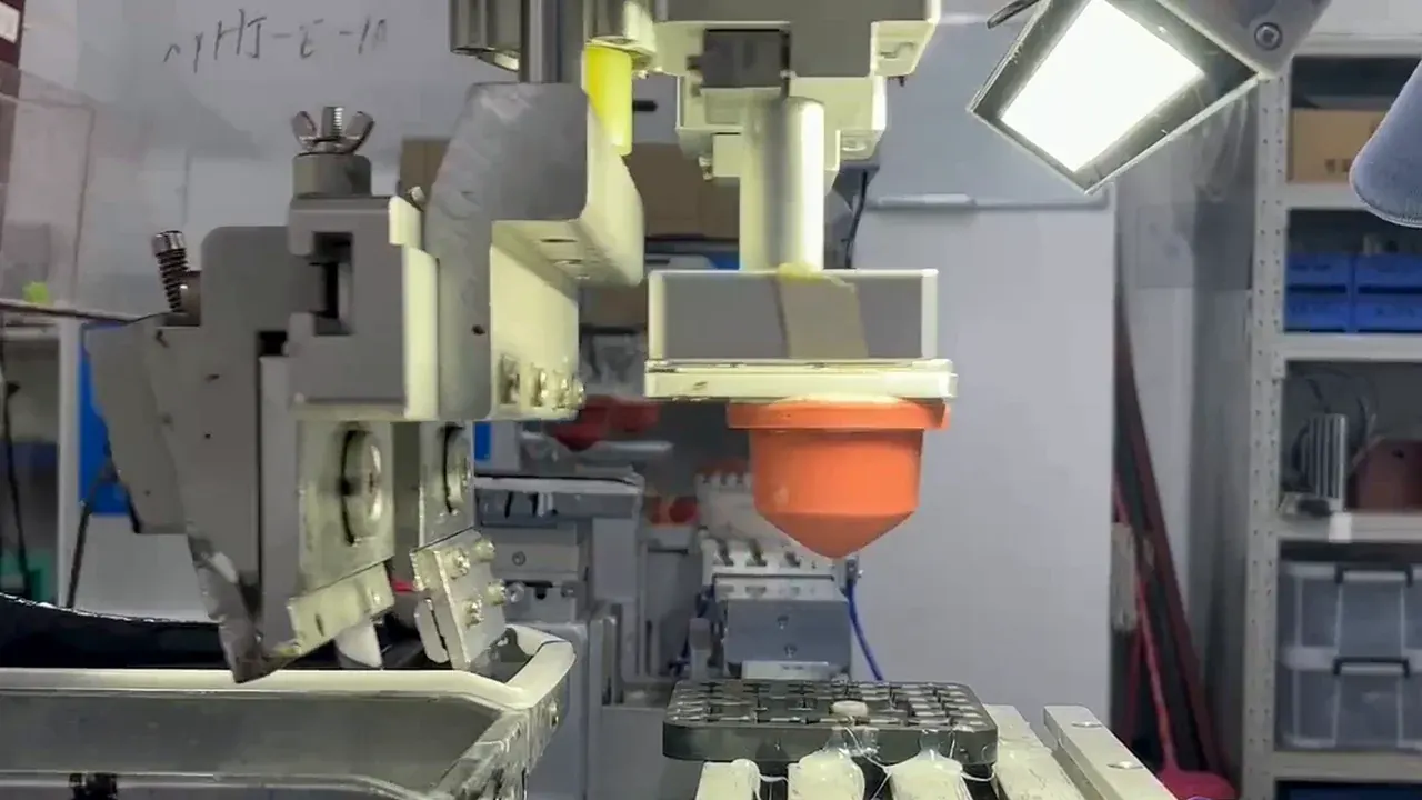 Pad printing equipment positioned above molded plastic housings