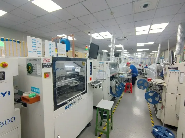 Surface-mount assembly equipment and component reels along the SMT workshop aisle