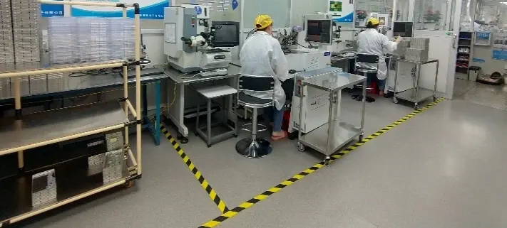 Operators at wire bonding equipment in a dedicated electronics work area